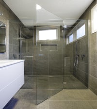 a bathroom with a glass shower door