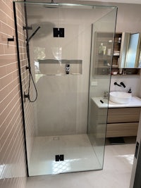 a bathroom with a glass shower stall